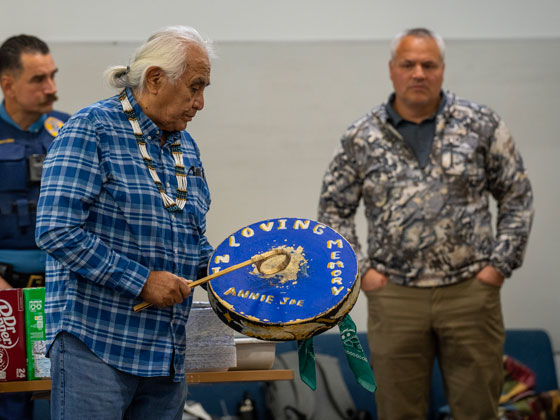 Former Attorney General Taylor watches the opening drum for the dancers at the Native Village of Tanacross during the 2024 TCC Partner Boat Trip.
